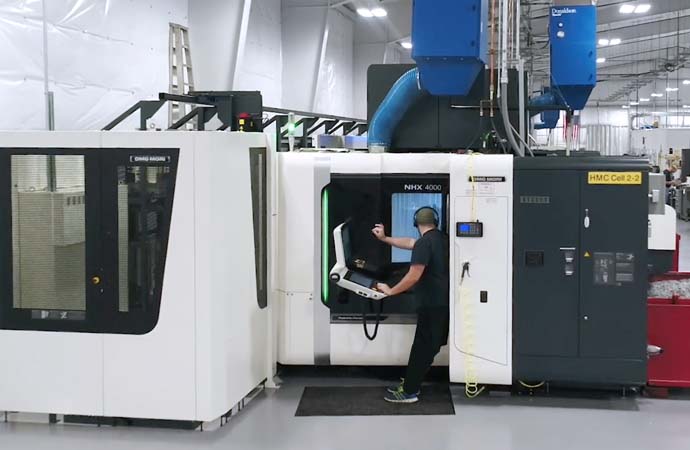 Macine operator at an automated cnc machining cell